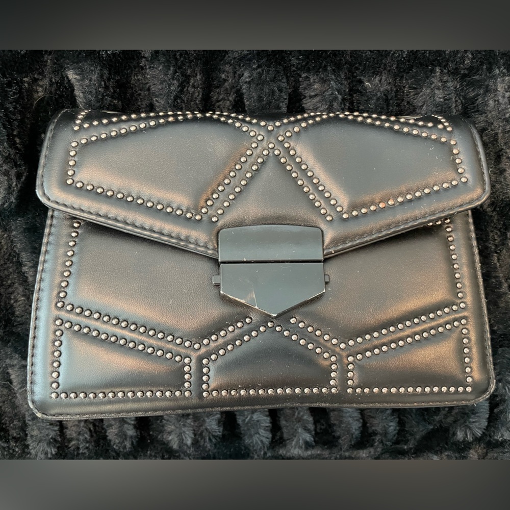 Black clasp purse with silver stud accents. No strap so add your own!